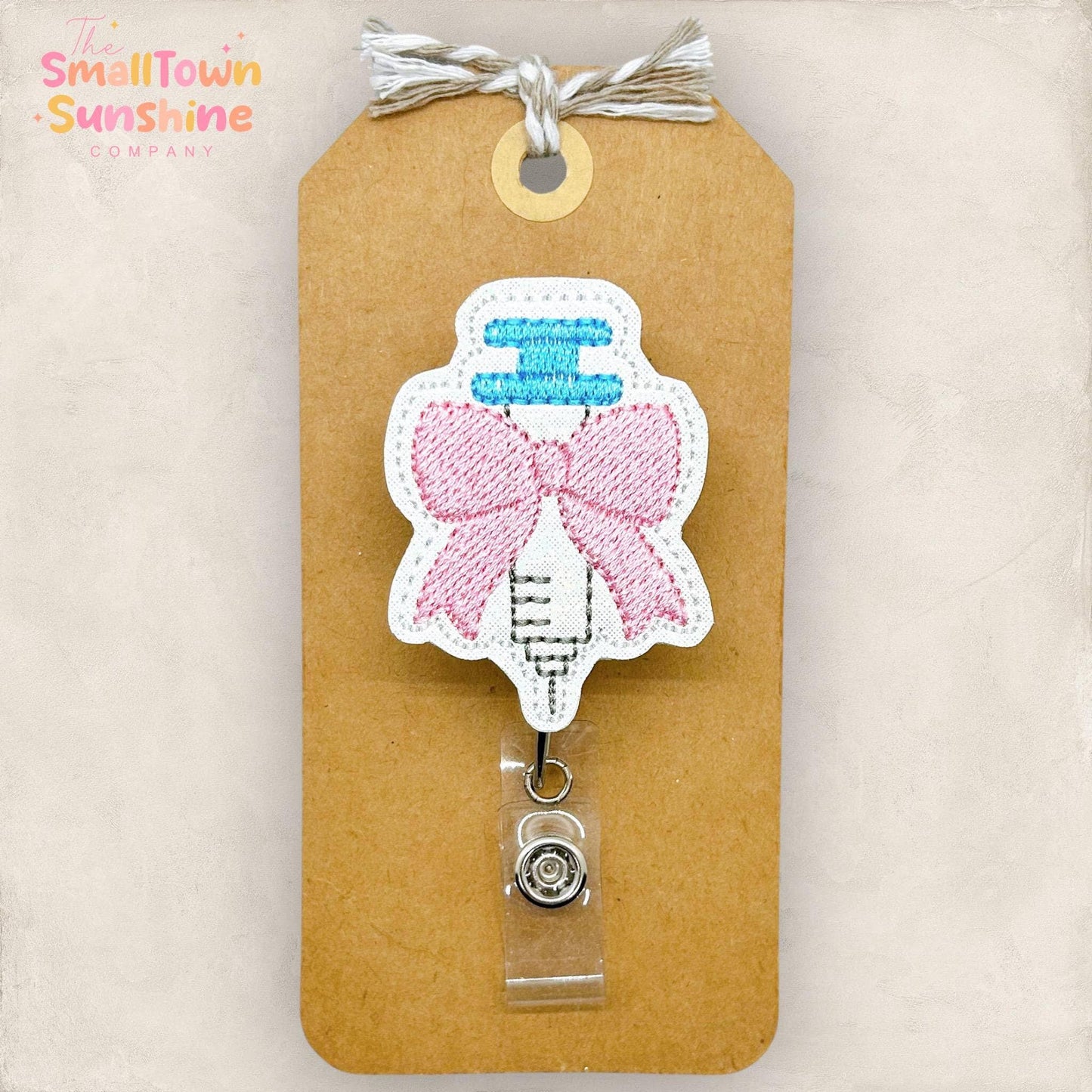 Syringe with Coquette Bow Badge Reel: White / Swivel