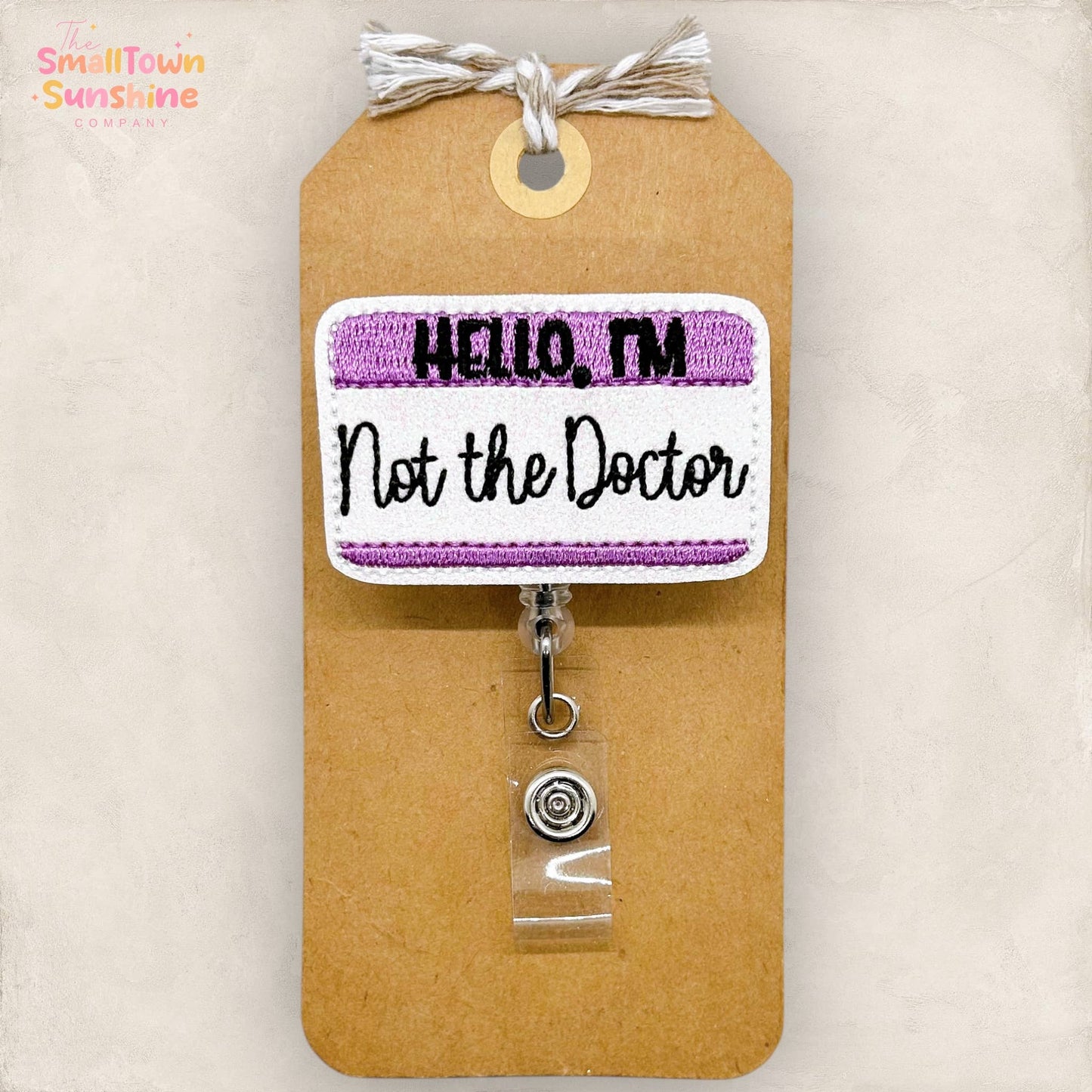 Hello, I'm Not the Doctor Badge Reel (purple): Black / Swivel