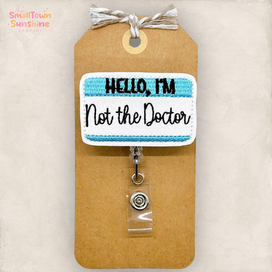 Hello, I'm Not the Doctor Badge Reel (blue): Black / Swivel