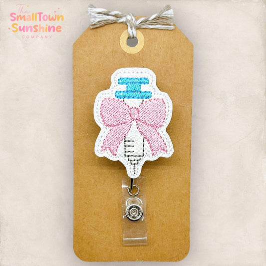 Syringe with Coquette Bow Badge Reel: White / Swivel
